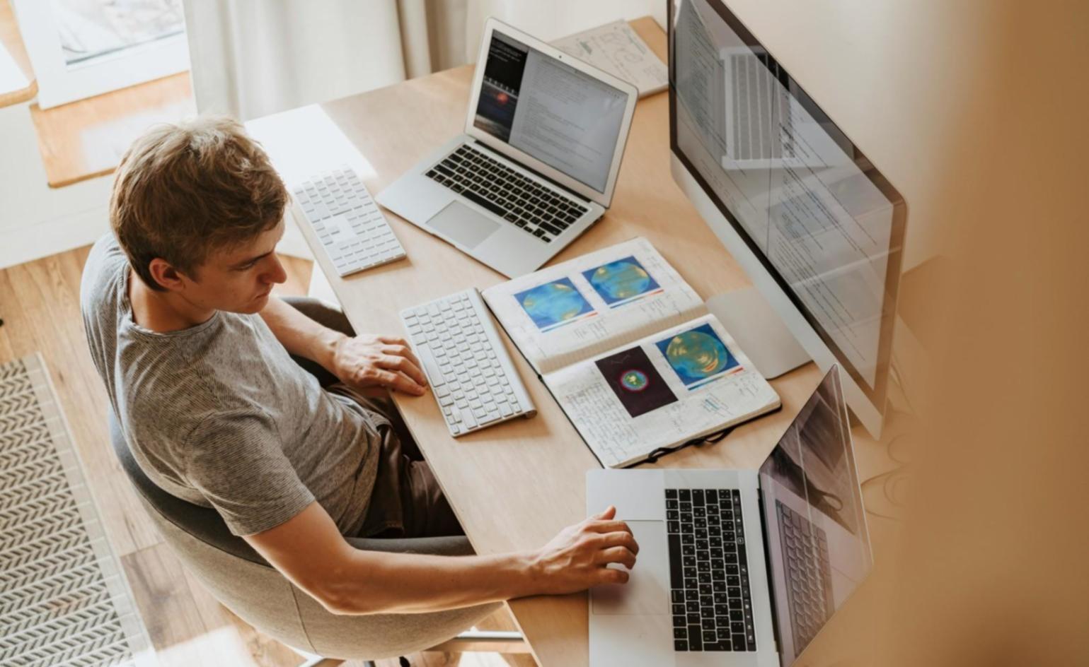 Modern workspace showing diverse team members collaborating on digital design projects